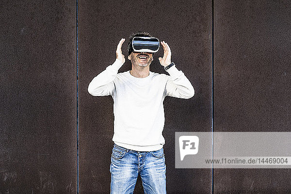 Mature man using VR glasses