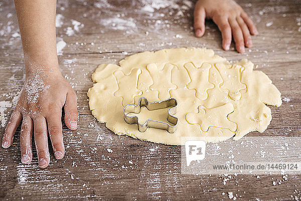 Boy cutting out cookies  close-up