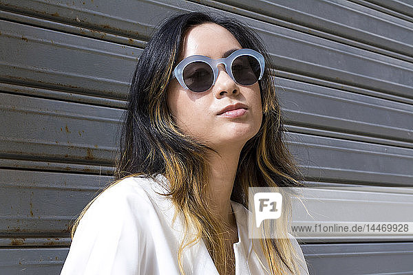 Portrait of young woman wearing fashionable sunglasses