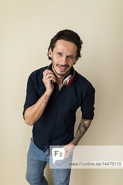 Portrait of a tattoed man with headphones