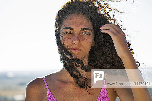 Portrait of teenage girl  hand in hair