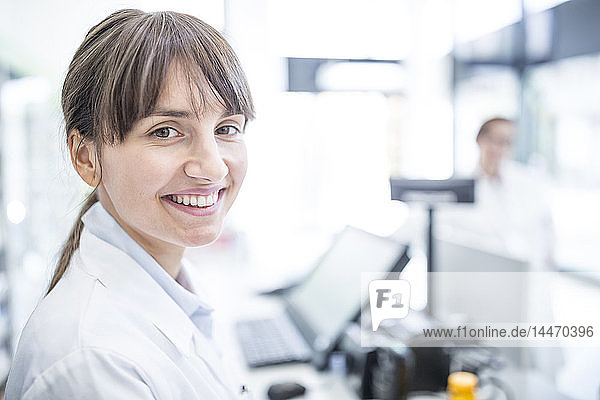 Porträt einer lächelnden Frau im Laborkittel