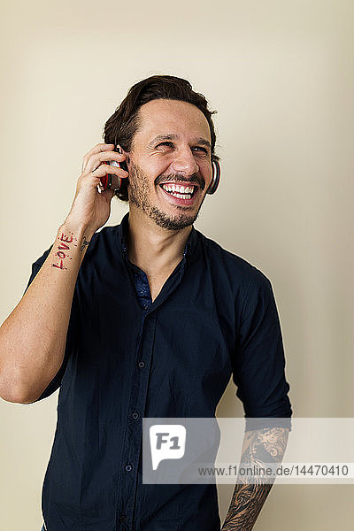 Portrait of a tattoed man with headphones