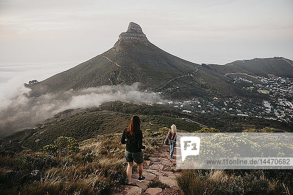 South Africa  Cape Town  Kloof Nek  two women on a trail at sunset