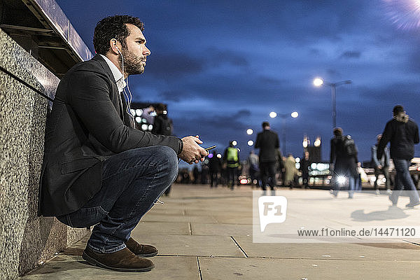 UK  London  thoughtful businessman in the city by night