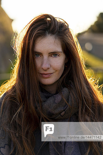 Portrait of smiling young woman with nose piercing in autumn