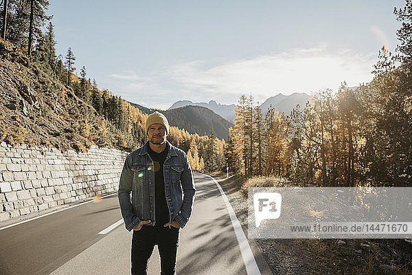 Man travelling through Switzerland  standing on road