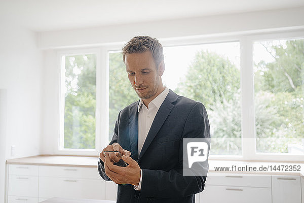 Geschäftsmann benutzt Glas-Touchscreen in einem neuen Heim