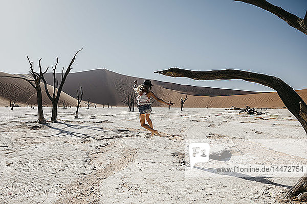 Namibia  Namib desert  Namib-Naukluft National Park  Sossusvlei  woman moving in Deadvlei