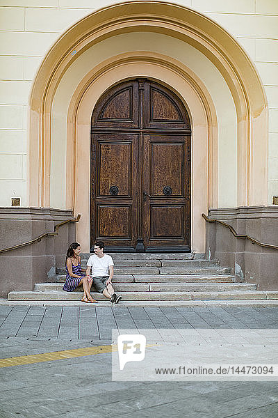 Verliebtes Ehepaar sitzt auf einer Treppe in der Stadt