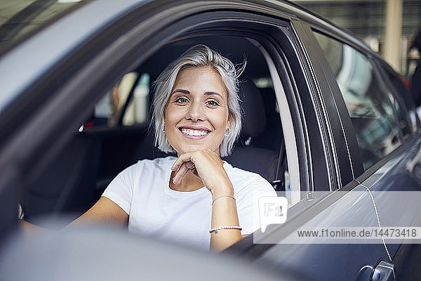 Young woman sitting in her car