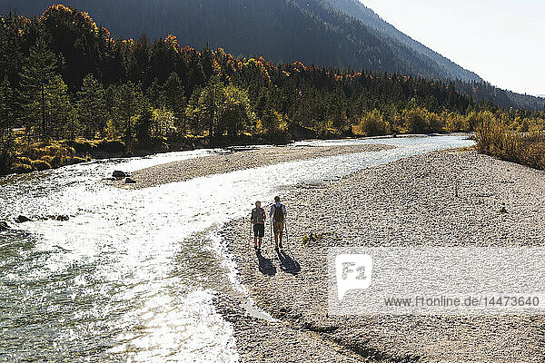 Austria  Alps  couple on a hiking trip walking along a brook