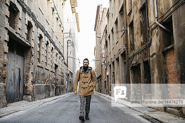 Spain  Igualada  man walking through the industrial zone of the town