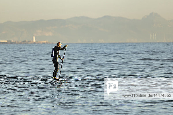 Spain  Andalusia  Tarifa  man stand up paddle boarding on the sea