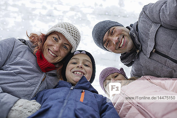 Family with two kids on the ice rink  portrait