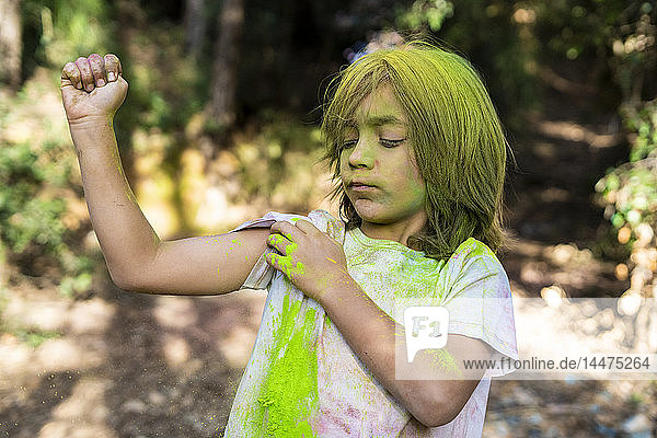 Boy full of colorful powder paint  celebrating Holi  Festival of Colors
