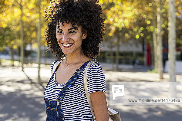 Portrait of a smiling woman  standing in a park