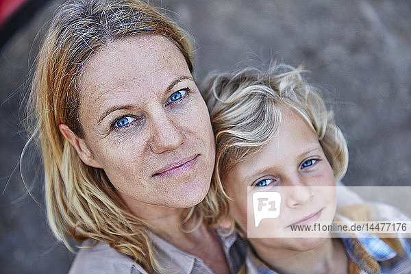 Portrait of smiling mother with son outdoors