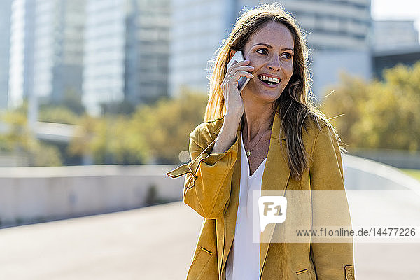 Happy woman on cell phone in the city