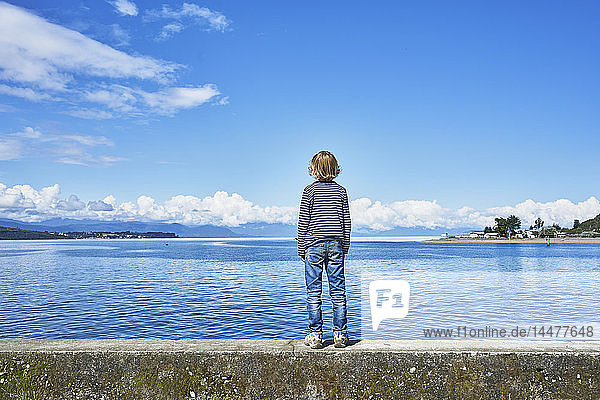 Chile  Puerto Montt  boy standing on quay wall at the harbor