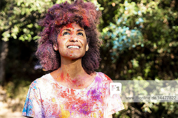 Woman full of colorful powder paint  celebrating Holi  Festival of Colors