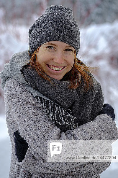 Porträt einer lächelnden Teenagerin im Winter im Freien