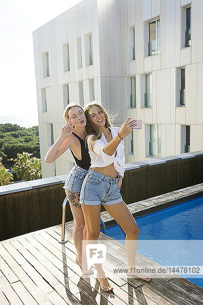 Freundinnen auf einer Dachterrasse  Spaß am Pool  Selbsthilfe