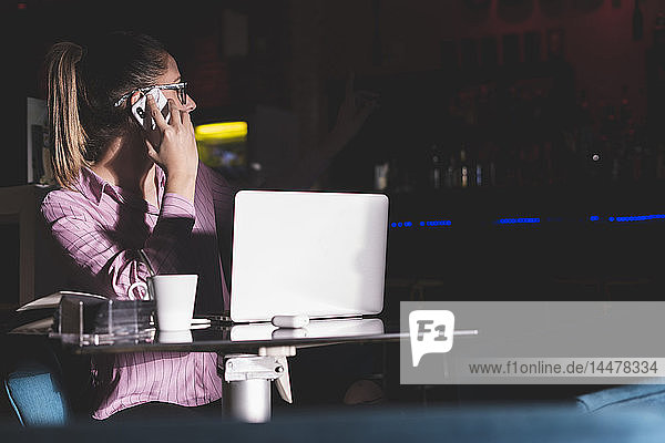 Woman working long hours sitting in a coffee shop