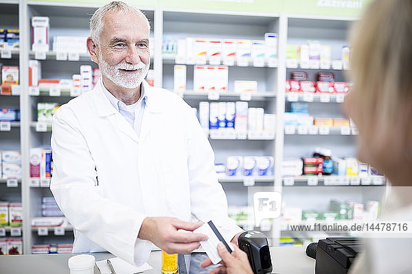 Customer paying cashless in a pharmacy