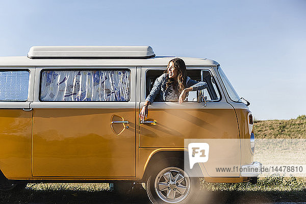 Pretty woman on a road trip with her camper  looking out of car window
