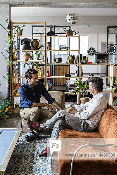 Two businessmen having a discussion in loft office