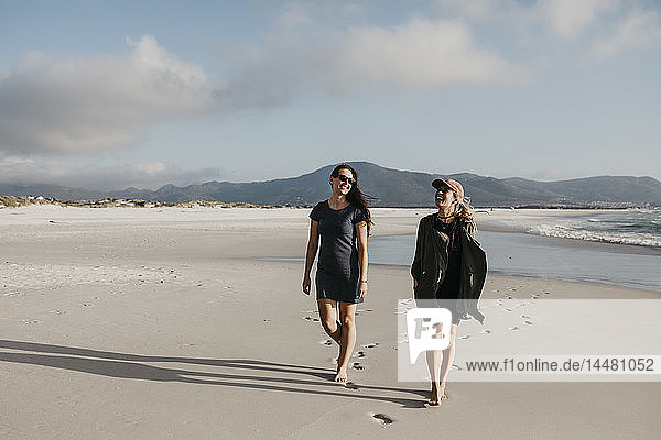 South Africa  Western Cape  Noordhoek Beach  two young women strolling on the beach