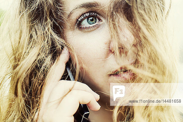 Portrait of young woman on the phone  close-up