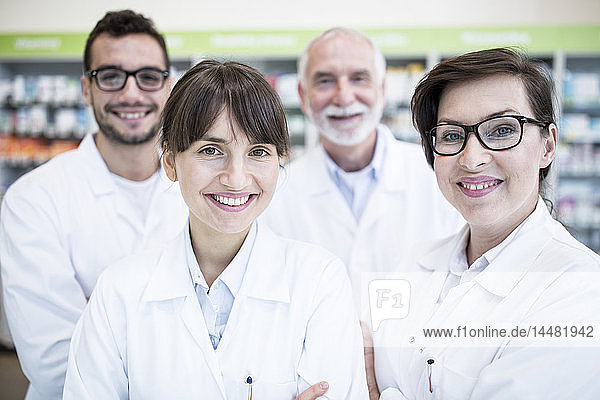 Portrait of smiling pharmacist team in pharmacy