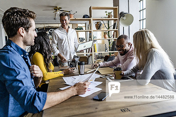 Confident business team having a meeting in loft office