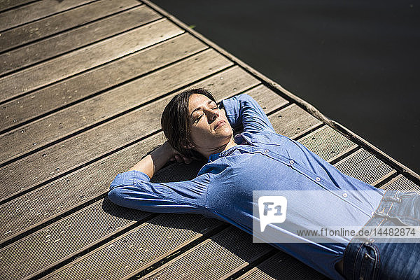 Reife Frau macht eine Pause  entspannt auf einem Steg