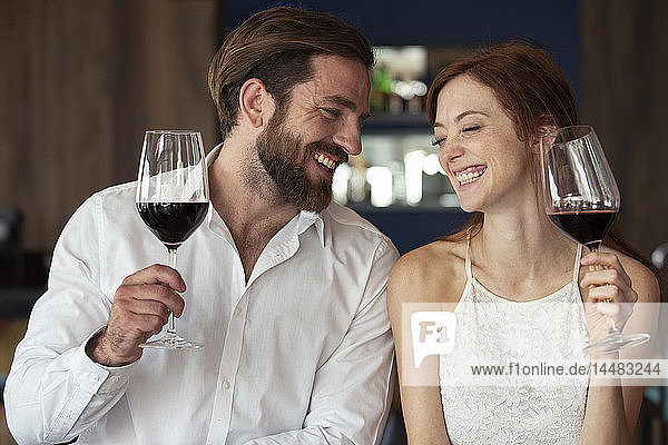 Smiling couple holding wine glass