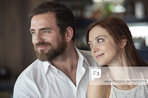 Smiling couple sitting in bar