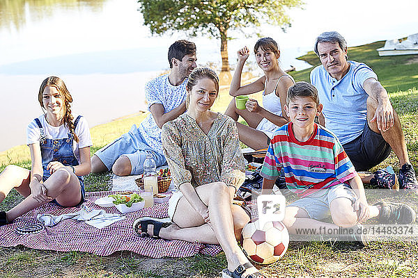 Family enjoying picnic near lake