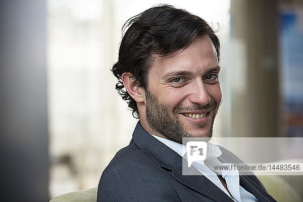 Close-up of businessman sitting in hotel lobby