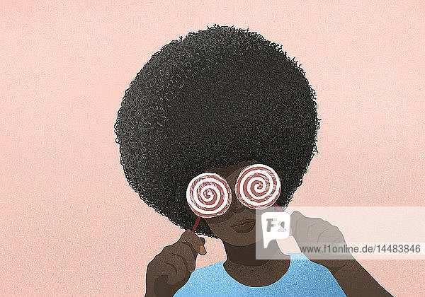 Portrait Frau mit Afro  die Lutscher über die Augen hält