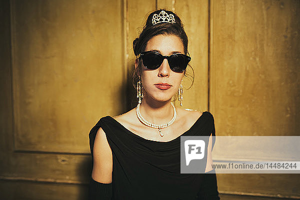 Porträt einer selbstbewussten  kühlen  eleganten Frau mit Sonnenbrille und Diadem