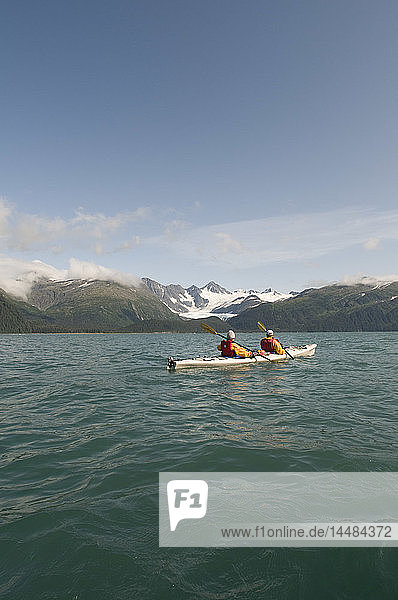 Grandfather and grandson sea kayaking in Prince William Sound  near Whittier  Southcentral  Alaska
