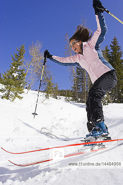 Young woman downhill skiing Dixie National Forest Utah Winter