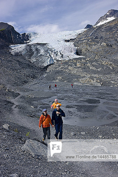Family hiking on a path in front of the Worthington Glacier  Chugach National Forest  Southcentral  Alaska