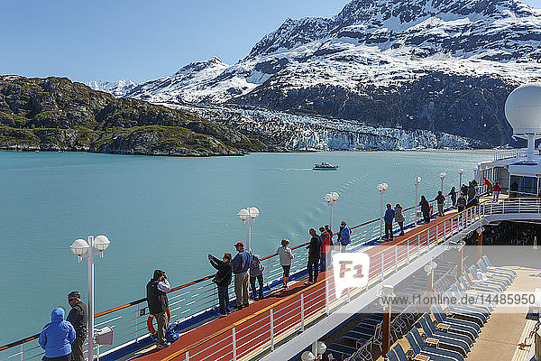 Visitors aboard a Pacific Princess Cruise ship view Margerie Glacier and Fairweather Mountains while in Tarr Inlet in Glacier Bay National Park in Southeast  Alaska