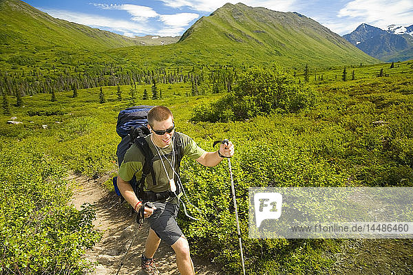 Male hiker on South Fork Eagle River Trail to Eagle Lake in Chugach Mountains Alaska Summer