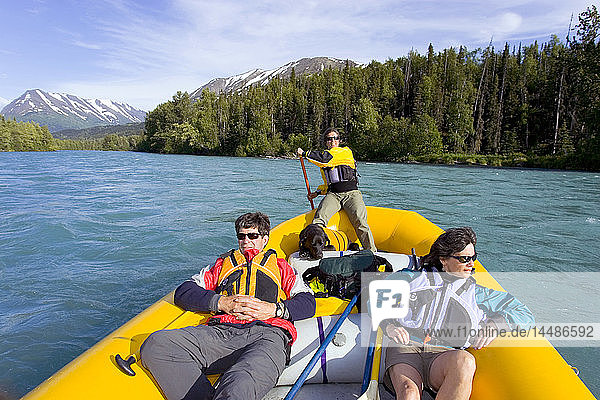 Couple river rafting w/guide & dog on Kenai River Kenai Peninsula Alaska Summer