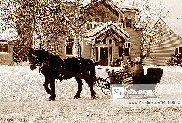 People on Sleigh Ride in Front of House Anchorage AK