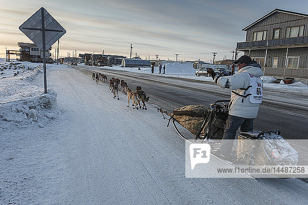 Steve Watkins runs down Front Street on his way to the finish line in Nome during Iditarod 2015